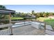 View of a wooden dock with a storage container, and waterfront homes in the distance at 1475 Kettledrum Trl, Deltona, FL 32725