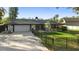 Charming single-story home featuring a well-manicured lawn and a fenced yard at 1475 Kettledrum Trl, Deltona, FL 32725