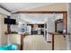 Open kitchen with tile floors and stainless steel appliances and dark cabinets at 1475 Kettledrum Trl, Deltona, FL 32725