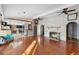 Spacious living room with hardwood floors, a brick fireplace, and an open-concept design at 1475 Kettledrum Trl, Deltona, FL 32725