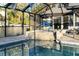 Backyard pool with spa and screen enclosure, perfect for year-round enjoyment and relaxation at 1475 Kettledrum Trl, Deltona, FL 32725