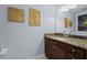 Bathroom featuring modern vanity with granite countertop, sleek fixtures, and decorative leaf art at 150 E Robinson St # 1007, Orlando, FL 32801
