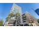 Modern high-rise building exterior with parking garage against a clear blue sky at 150 E Robinson St # 1007, Orlando, FL 32801