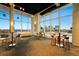 Light-filled common area offering city views through large windows, tables, chairs and contemporary furniture at 150 E Robinson St # 1007, Orlando, FL 32801