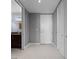 Hallway leading to a bathroom with vanity, storage and white cabinets against marble floors at 150 E Robinson St # 1007, Orlando, FL 32801