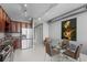 Modern kitchen and dining area with stainless steel appliances and a glass top dining table at 150 E Robinson St # 1007, Orlando, FL 32801