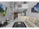 Stylish living room with spiral staircase, open floor plan, and contemporary furnishings at 150 E Robinson St # 1007, Orlando, FL 32801