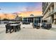 Comfortable rooftop patio with blue outdoor furniture and city views at sunset at 150 E Robinson St # 1007, Orlando, FL 32801