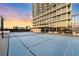 Rooftop tennis court, offering residents a unique recreational amenity with residential tower in the background at 150 E Robinson St # 1007, Orlando, FL 32801