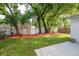 Landscaped backyard featuring a grass lawn with a concrete patio and a wooden fence at 1505 25Th St, Orlando, FL 32805