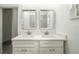 This bathroom features dual vanity sinks, tiled floors, and well-lit mirrors at 1505 25Th St, Orlando, FL 32805