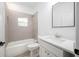The bathroom features a shower and tub combo with tile surround and a single sink vanity at 1505 25Th St, Orlando, FL 32805