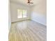 Spacious bedroom with wood-look tile flooring, a ceiling fan, and a bright window at 1505 25Th St, Orlando, FL 32805