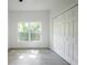 A bright bedroom features wood-look tile flooring, a closet, and a window for lots of natural light at 1505 25Th St, Orlando, FL 32805