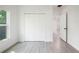 The bedroom features a large closet, wood-look tile flooring, and a window for natural light at 1505 25Th St, Orlando, FL 32805