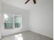 Bright bedroom features tile flooring, a ceiling fan, and a window that allows for ample natural light at 1505 25Th St, Orlando, FL 32805