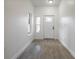 Bright entryway featuring wood-look tile floors, white walls, and a classic front door with glass inserts at 1505 25Th St, Orlando, FL 32805