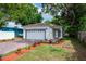 Beautiful home exterior with a garage, brick-paved driveway, manicured landscaping, and mature trees at 1505 25Th St, Orlando, FL 32805