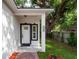 Home exterior with a front porch, white door, and manicured front yard at 1505 25Th St, Orlando, FL 32805