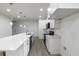 A well-lit kitchen with white cabinets, stainless steel appliances, and a large island with a white countertop at 1505 25Th St, Orlando, FL 32805