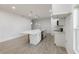 Bright kitchen with white cabinets, an island with a white countertop, and modern stainless steel appliances at 1505 25Th St, Orlando, FL 32805