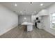Kitchen with an island, pendant lighting, white cabinetry, and tile floors at 1505 25Th St, Orlando, FL 32805