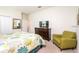 Neutral bedroom featuring stylish decor, a queen-sized bed, and a comfortable sitting chair at 1551 Observer Ln, Davenport, FL 33896