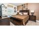 Comfortable bedroom featuring stylish decor, a queen-sized bed, and dark wood furnishings at 1551 Observer Ln, Davenport, FL 33896