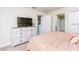 Bright bedroom with a dresser and television, providing ample space and comfort at 1551 Observer Ln, Davenport, FL 33896