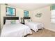 Charming bedroom with two twin beds, colorful artwork, and a bright window at 1551 Observer Ln, Davenport, FL 33896