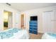 Spacious bedroom with twin beds, an en-suite bathroom, and ample storage space at 1551 Observer Ln, Davenport, FL 33896