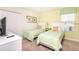 Cozy bedroom featuring two twin beds, closet, and a bright window at 1551 Observer Ln, Davenport, FL 33896