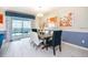 Bright dining room features modern chandelier, dining table set, and sliding glass door to the pool area at 1551 Observer Ln, Davenport, FL 33896