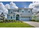 Charming two-story home featuring a well-manicured lawn and a two-car garage at 1551 Observer Ln, Davenport, FL 33896