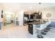 Open concept kitchen featuring dark cabinetry, stainless steel appliances, and a breakfast bar at 1551 Observer Ln, Davenport, FL 33896