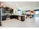 Modern kitchen with stainless steel appliances and ample counter space overlooks the living area at 1551 Observer Ln, Davenport, FL 33896