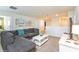 Comfortable living room featuring a gray sofa, white coffee table, and modern decor at 1551 Observer Ln, Davenport, FL 33896