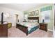 Comfortable main bedroom with a king bed, stylish decor, and natural light at 1551 Observer Ln, Davenport, FL 33896