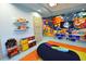 Vibrant playroom featuring colorful wall art, a TV, and -friendly furniture at 1551 Observer Ln, Davenport, FL 33896