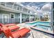 Lounge by the pool, with outdoor seating, perfect for relaxation and entertaining in style at 1551 Observer Ln, Davenport, FL 33896