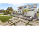 Beautiful backyard with lush landscaping, a modern waterfall feature, and stairs leading to the upper level at 15633 Panther Lake Dr, Winter Garden, FL 34787