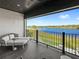 Enjoy the waterfront views from this relaxing balcony with comfortable seating and stylish decor at 15633 Panther Lake Dr, Winter Garden, FL 34787