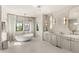 Elegant bathroom featuring a free-standing tub, double vanity, and lots of natural light at 15633 Panther Lake Dr, Winter Garden, FL 34787