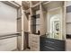 Custom closet design featuring built-in shelving, drawers, and a mirrored dressing area at 15633 Panther Lake Dr, Winter Garden, FL 34787