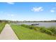 Scenic view of a dock stretching into a serene lake surrounded by lush greenery and neighborhood homes at 15633 Panther Lake Dr, Winter Garden, FL 34787