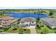 Stunning two-story home with a tile roof, pristine landscaping, and a picturesque waterfront view at 15633 Panther Lake Dr, Winter Garden, FL 34787