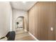 Hallway featuring wood slat accent wall, arched doorway, and light hardwood flooring at 15633 Panther Lake Dr, Winter Garden, FL 34787