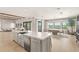Open-concept kitchen with an island, stainless steel appliances, and a dining area with natural light at 15633 Panther Lake Dr, Winter Garden, FL 34787