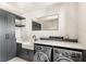 Well-equipped laundry room with front-load washer/dryer, sink, and modern cabinetry at 15633 Panther Lake Dr, Winter Garden, FL 34787