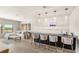 Entertain in this living area featuring modern bar with ample seating and contemporary lighting at 15633 Panther Lake Dr, Winter Garden, FL 34787